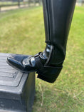Load image into Gallery viewer, Equisole EXternal-Weighted Training Aid for Equestrians, featuring a black riding boot secured on a stirrup step.