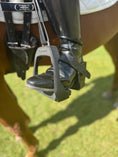 Load image into Gallery viewer, Equisole External-Weighted Training Aid by Southlake Paws, featuring a black stirrup attached to a riding boot on a horse.