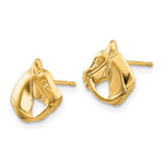 Gold horse head earrings on a white background
