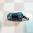 Load image into Gallery viewer, Chicago Handshake Poop Bag Holder by Southlake Paws features a colorful design with bottles and a carabiner clip for easy att