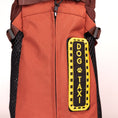 Load image into Gallery viewer, Orange dog backpack featuring a black and yellow "DOG TAXI" patch with a paw print design. Ideal for pet transport.