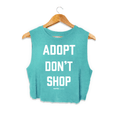 Load image into Gallery viewer, Turquoise crop top with bold white text reading "ADOPT DON'T SHOP," designed for dog lovers. Made in the USA.