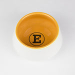 White and yellow ceramic dog bowl
