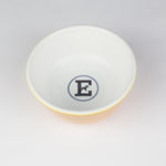 Yellow and white ceramic dog bowl