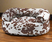 Bowsers Pet Products premium orthopedic donut dog bed with brown and white cow print cushion