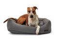 Load image into Gallery viewer, Dog resting comfortably on a Lark Graphite Napper Bed by Southlake Paws, featuring a soft, gray fabric design.