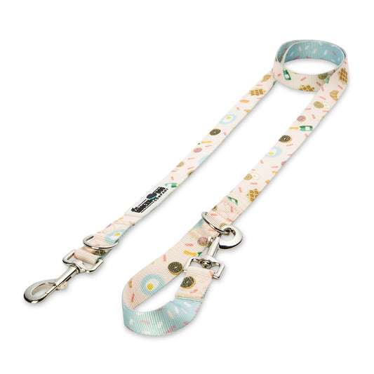 Colorful dog leash featuring a "Bottomless Brunch" design with donuts and brunch items, silver hardware, and a comfortable gr