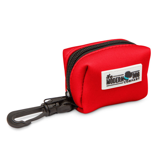 Ruby Red Poop Bag Holder by The Modern Dog Company, featuring a zippered design and a clip for easy attachment.