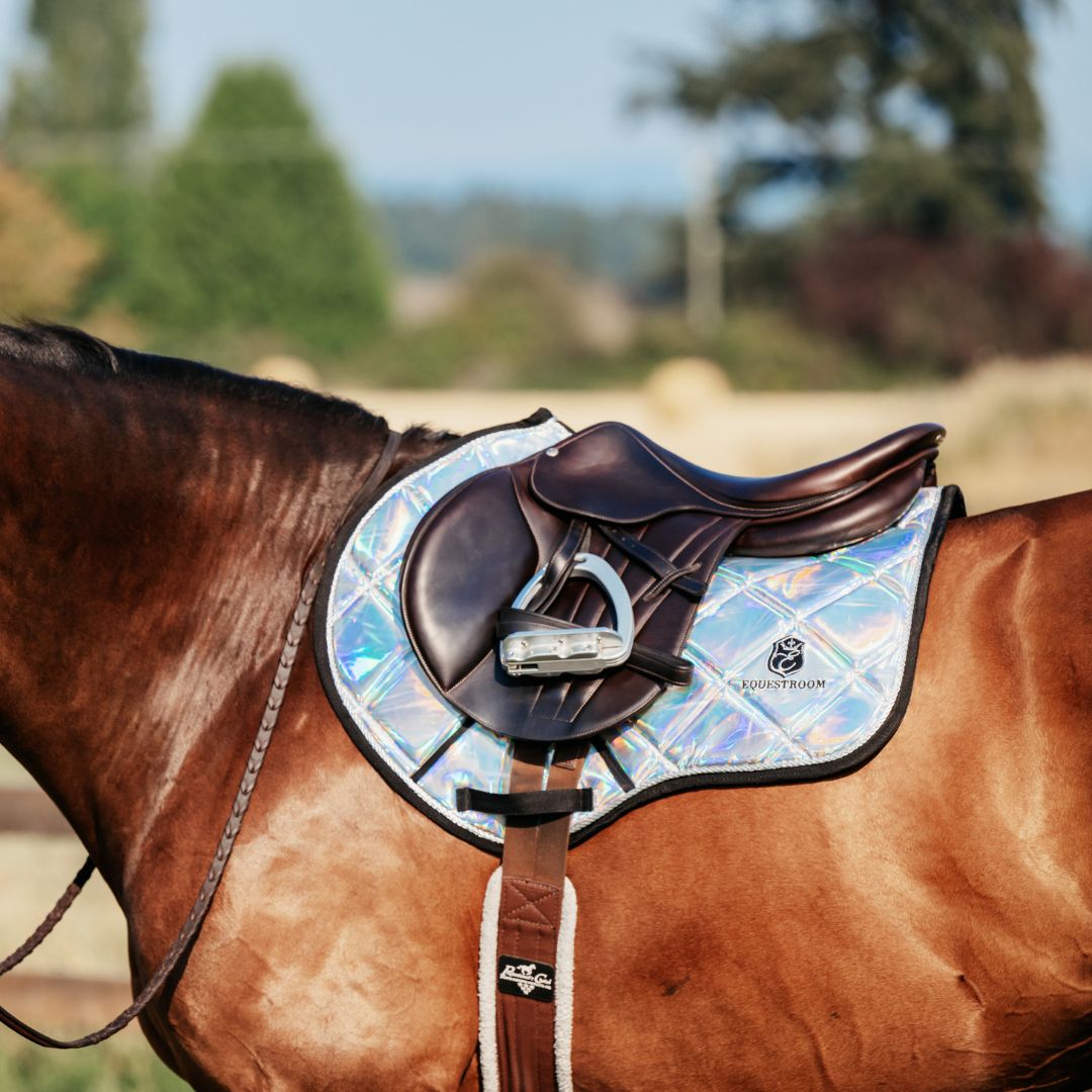 Holographic Saddle Pad by Southlake Paws on a brown horse, featuring a shiny, iridescent design and a brown saddle.