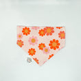 Load image into Gallery viewer, Flower Power Daisy Bandana by Southlake Paws featuring a pink background with colorful floral patterns in orange and yellow.
