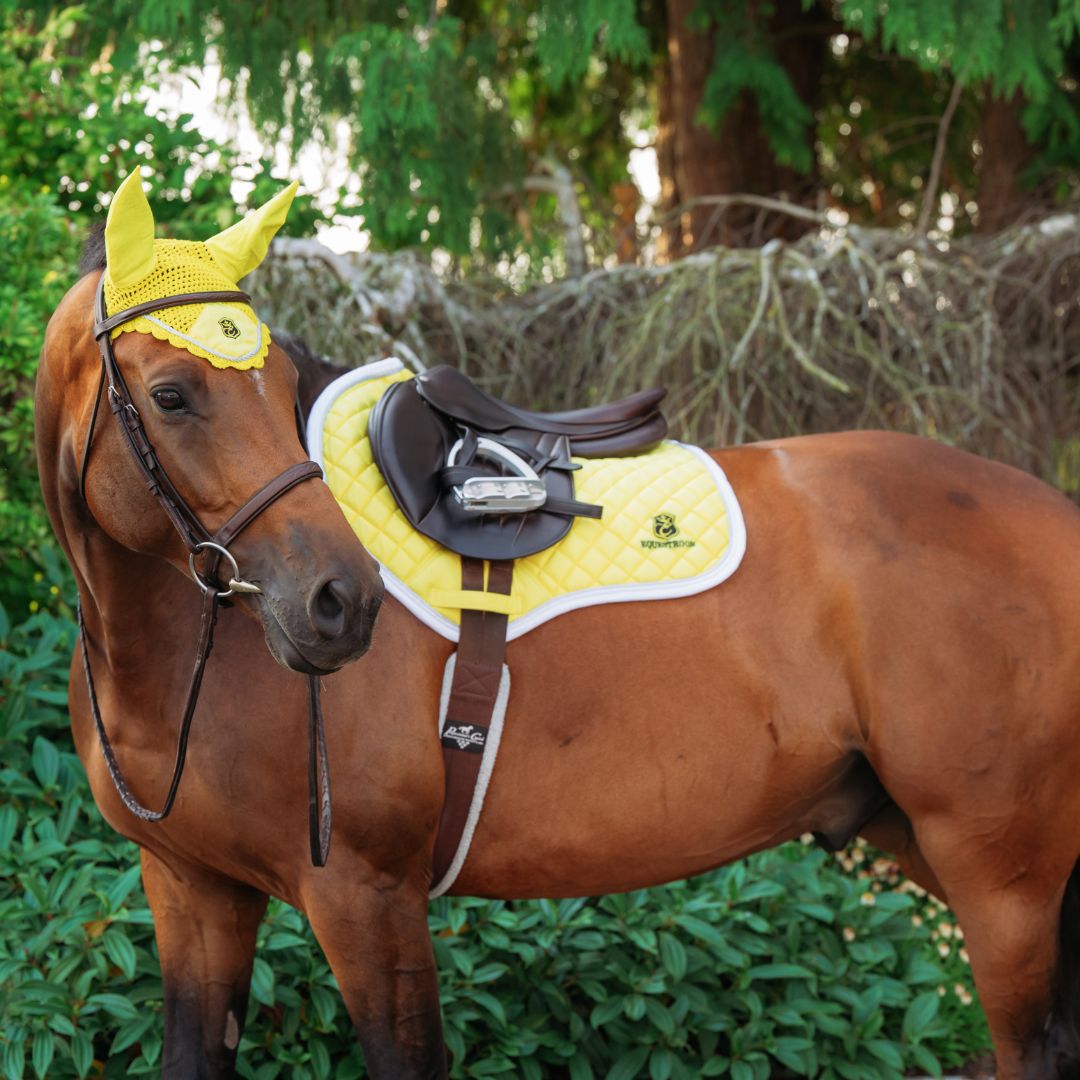 Southlake Paws Mimosa Saddle Pad on a brown horse, featuring a bright yellow quilted design and matching ear bonnet.