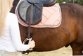 Load image into Gallery viewer, Powder Pink Suede Saddle Pad Set by Southlake Paws on a horse, featuring a quilted design and a rider holding the reins.
