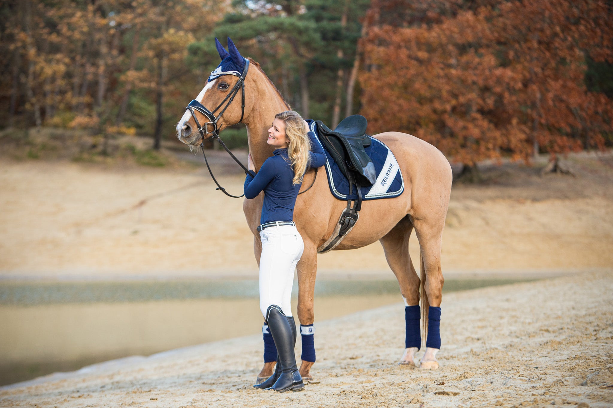 Southlake Paws Patriot American Saddle Pad Set featuring a rider in navy attire with a horse on a sandy shore.