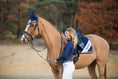 Load image into Gallery viewer, Southlake Paws Patriot American Saddle Pad Set featuring a rider in navy attire with a horse, set against a natural backdrop.
