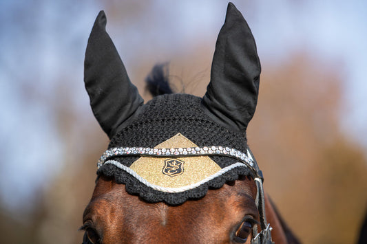 Southlake Paws Astris Fly Hat featuring a black design with a sparkling gold and crystal accent on a horse's head.