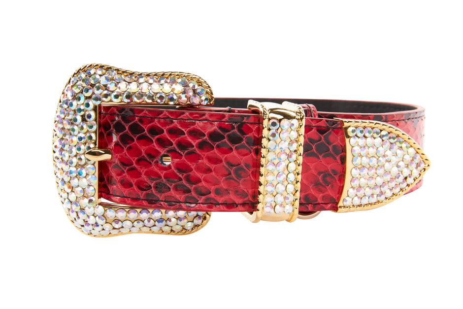 Red snake print belt with a large decorative buckle on a white background