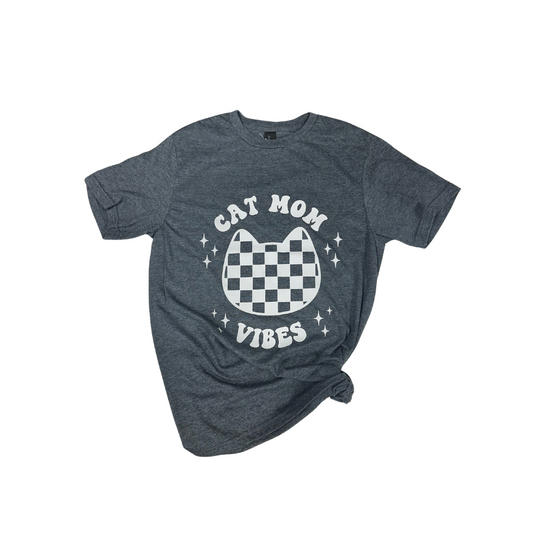 Gray t-shirt featuring a cat face graphic with "CAT MOM VIBES" text and a checkerboard pattern.