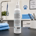 Load image into Gallery viewer, Southlake Paws Deep Cleaning Paw Spray for Dogs in a white spray bottle with instructions on the back, set against a grooming
