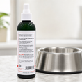 Load image into Gallery viewer, Southlake Paws Doggy Dental Spray & Water Additive in a green bottle, placed beside a stainless steel dog bowl.
