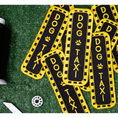 Load image into Gallery viewer, Southlake Paws Dog Taxi Patch featuring a black background with yellow text and accents, arranged on a green surface.
