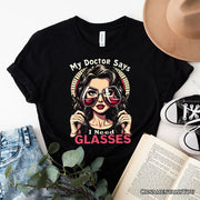 I Need Glasses Funny Wine T-Shirt, Retro Glam Black Tee for Stylish and Witty Women 