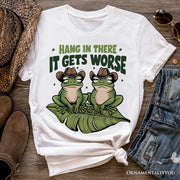 Hang In There It Gets Worse T-Shirt, White and Natural Funny Frog Tee with Dark Millennial Humor 
