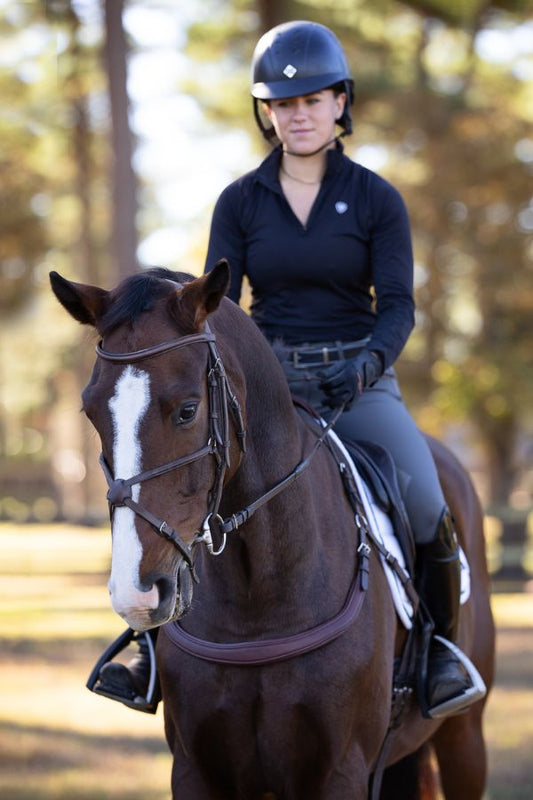 Southlake Paws Free Motion Breastplate on a horse, rider in black attire, outdoors with trees in the background.