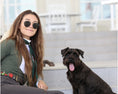 Load image into Gallery viewer, Southlake Paws TKC Exclusive Holiday Beaded Belt worn by a woman sitting next to a black dog on outdoor steps.
