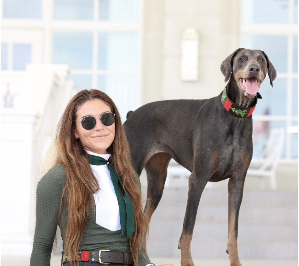 Southlake Paws TKC Exclusive Holiday Beaded Belts showcased on a woman and a happy dog, set against a stylish outdoor backdro