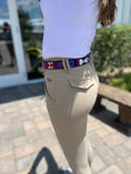 Load image into Gallery viewer, TKC Red White and Blue Belt in Wide Width with brass buckle, worn with beige riding pants, outdoors.
