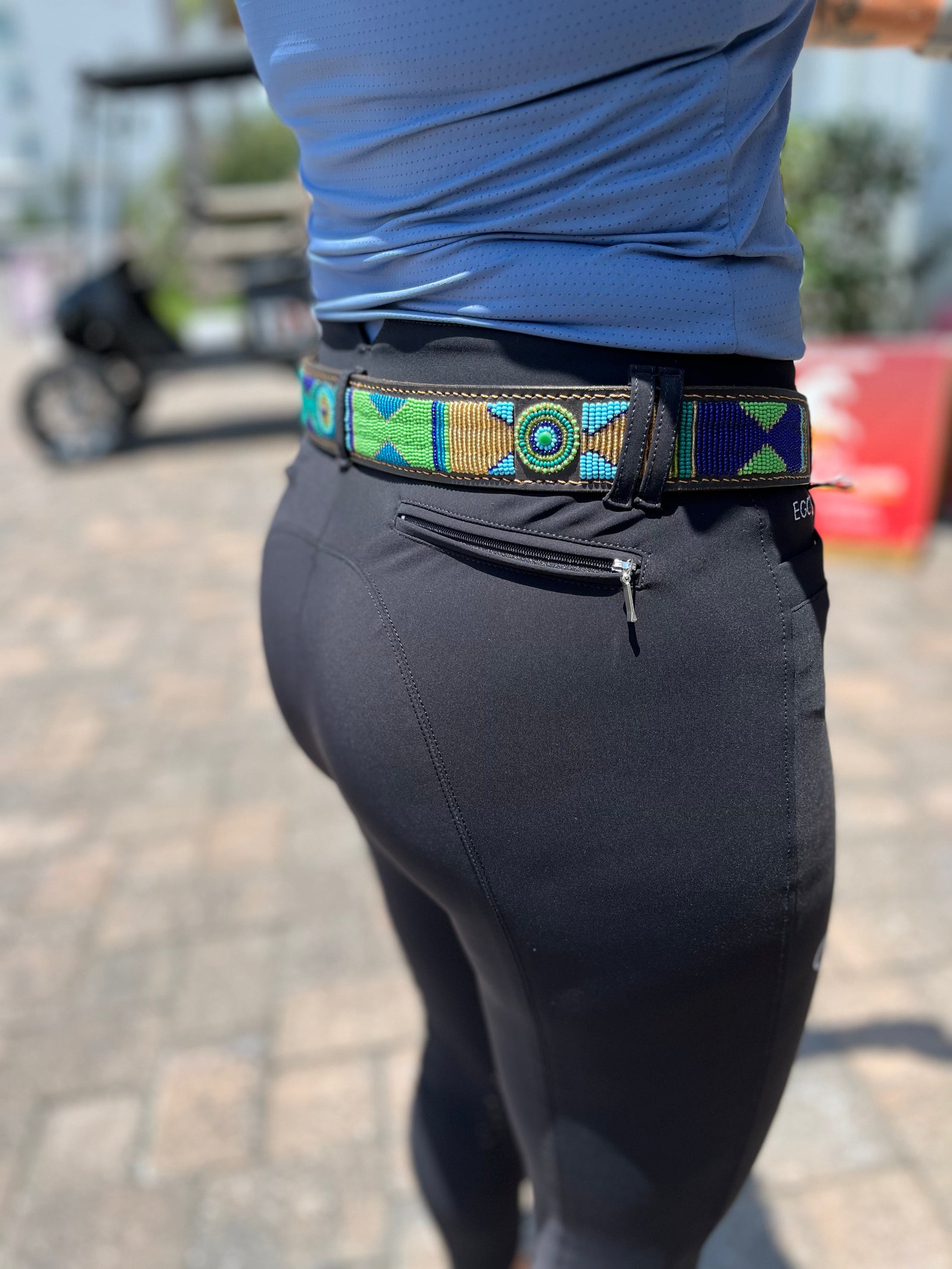 Southlake Paws TKC Peacock Belt in Standard Width, featuring a colorful geometric design, worn with black pants.