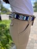 Load image into Gallery viewer, TKC Evil Eye Wide Width Belt by Southlake Paws featuring a silver buckle and colorful eye design, worn with beige pants.
