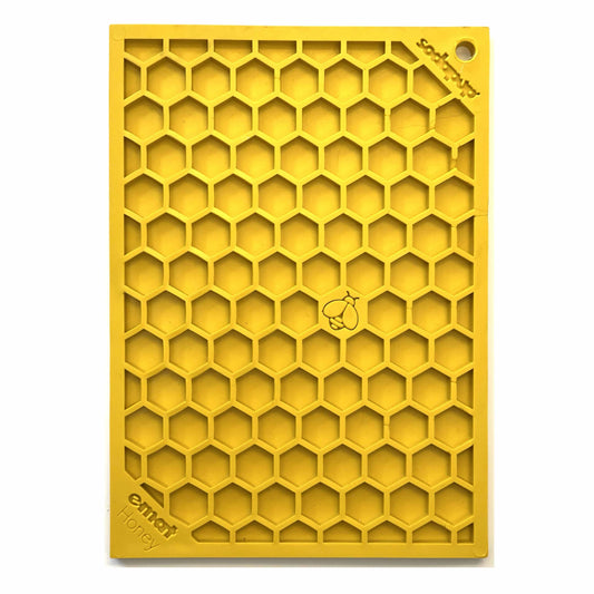 Yellow honeycomb-patterned silicone enrichment lick mat for dogs and cats, designed for anxiety relief and interactive play.