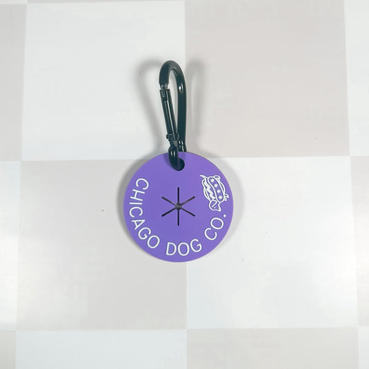 Purple Chicago Dog Co Colorful Poop Loops tag with a black carabiner for easy attachment. Ideal for pet waste disposal.