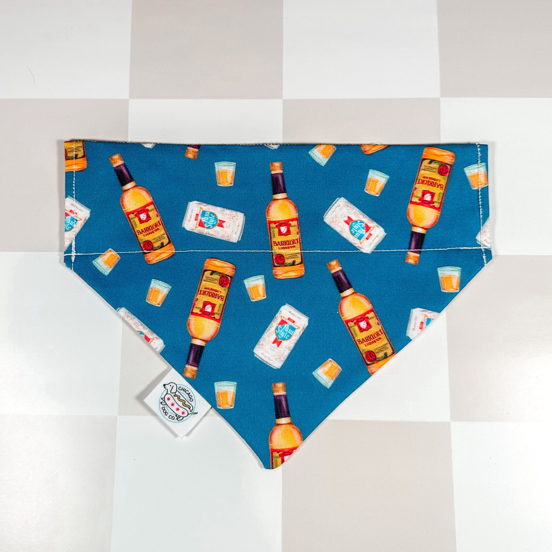 Chicago Handshake Bandana by Southlake Paws featuring a fun pattern of bottles and drinks on a blue background.
