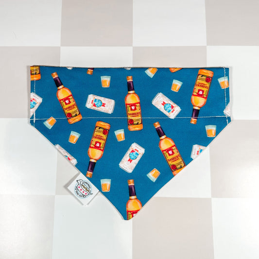 Chicago Handshake Bandana by Southlake Paws featuring a fun pattern of bottles and drinks on a blue background.