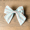 Load image into Gallery viewer, Chicago Flag Sailor Bow Tie by Southlake Paws featuring light blue stripes and red stars on a white background.
