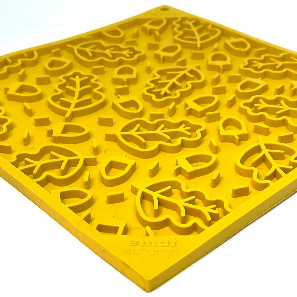 Yellow enrichment lick mat featuring a fall leaves design, ideal for dogs and cats. Perfect for mealtime fun.