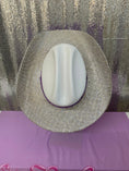 Load image into Gallery viewer, Round metallic object with a white center on a purple surface
