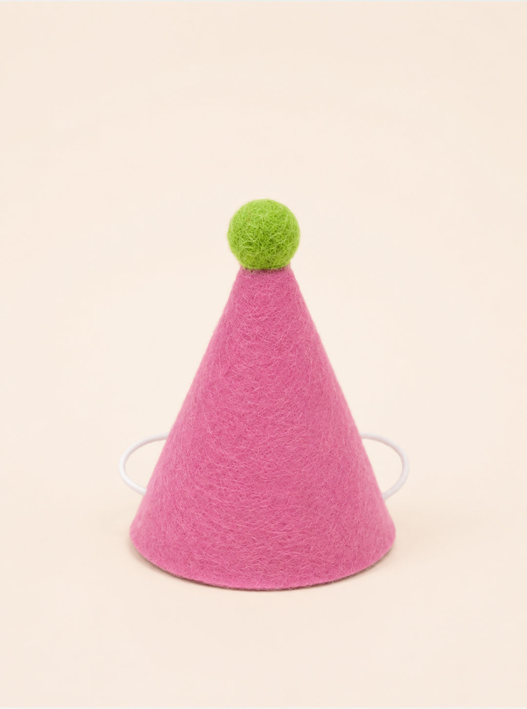 Pink felt party hat with a green pom-pom on top and elastic straps for secure wear, designed for pets by Southlake Paws.