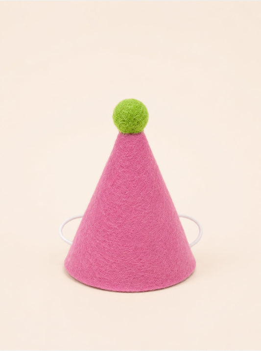 Pink felt party hat with a green pom-pom on top and elastic straps for secure wear, designed for pets by Southlake Paws.