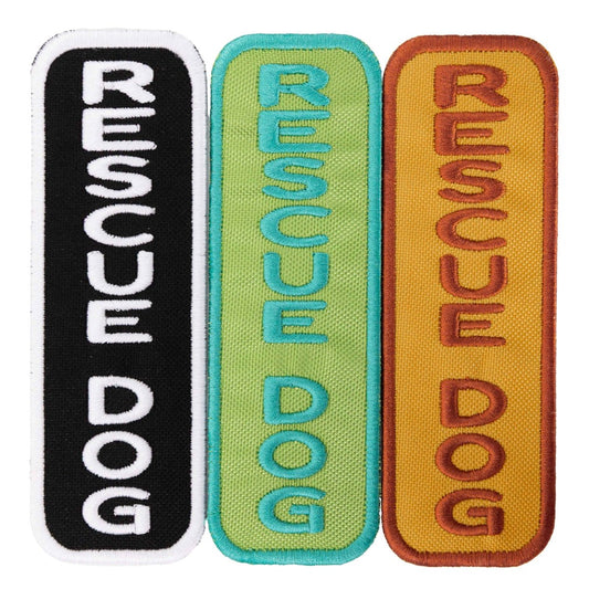 Three embroidered patches from Southlake Paws featuring the words "RESCUE DOG" in black, green, and orange on colorful backgr