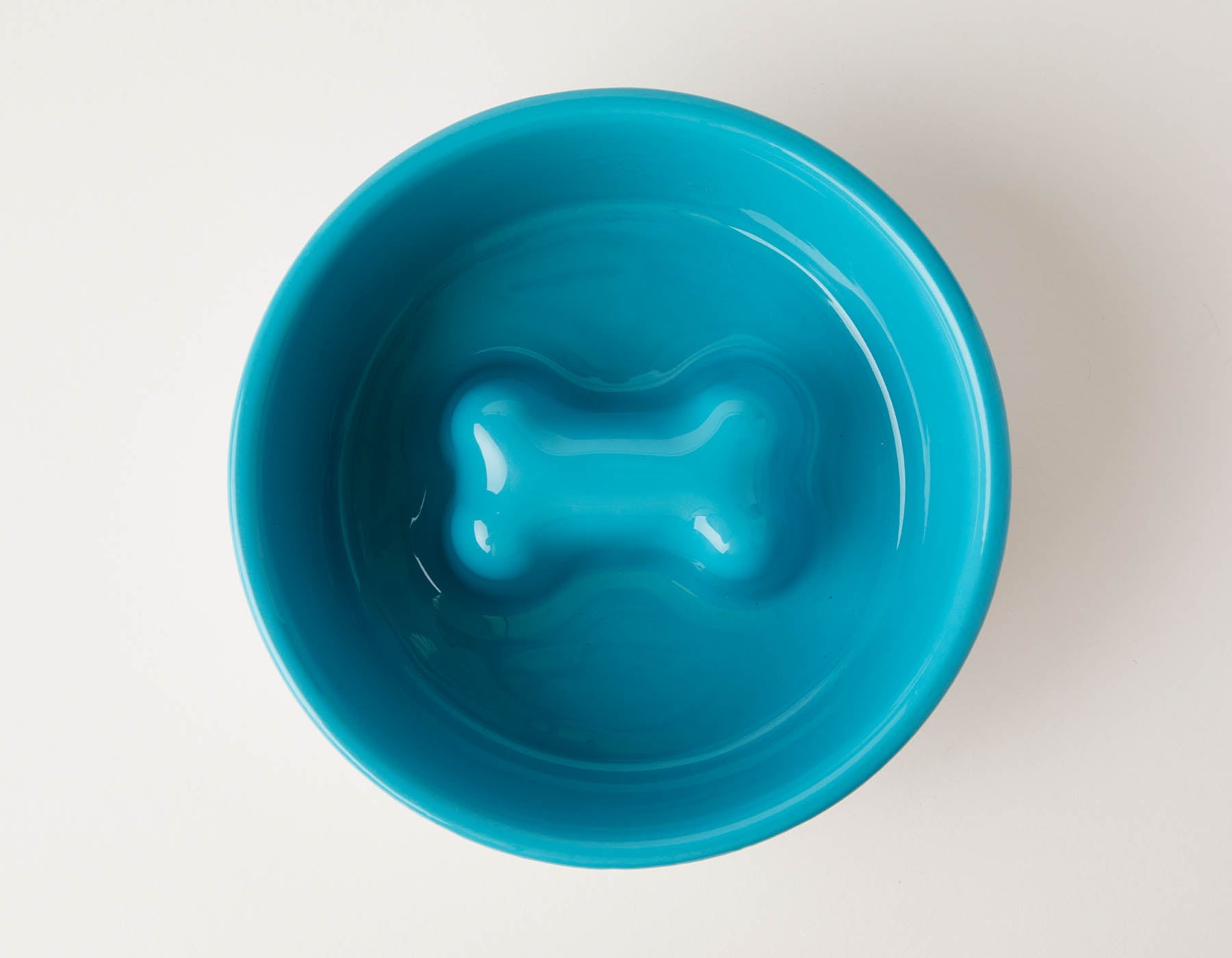 Blue slow feeder dog bowl by Southlake Paws, featuring an anti-slip stainless steel base and a bone-shaped design inside.