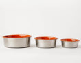 Load image into Gallery viewer, Slow Feeder Dog Bowl Orange by Southlake Paws, featuring three stainless steel bowls with anti-slip orange rims.

