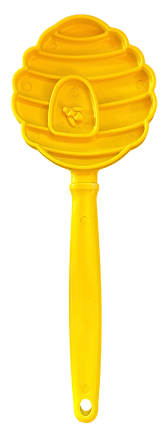 Southlake Paws eStick Hand-Held Dog Enrichment Toy in yellow, shaped like a honeycomb with a handle for interactive licking.