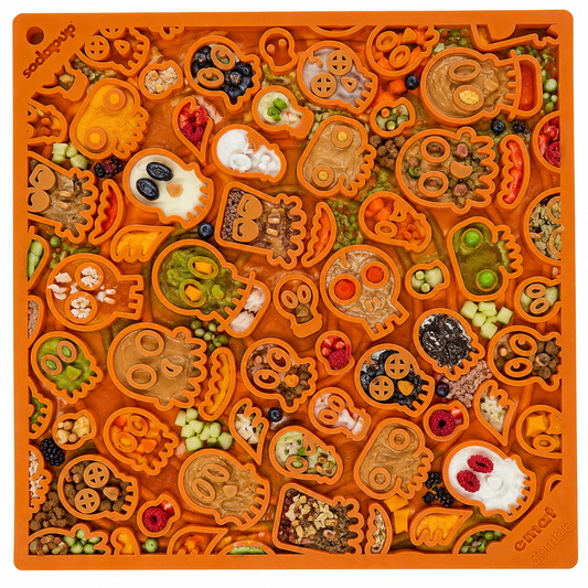 Orange enrichment lick mat featuring a Halloween skull design with various shapes for dogs and cats to enjoy.