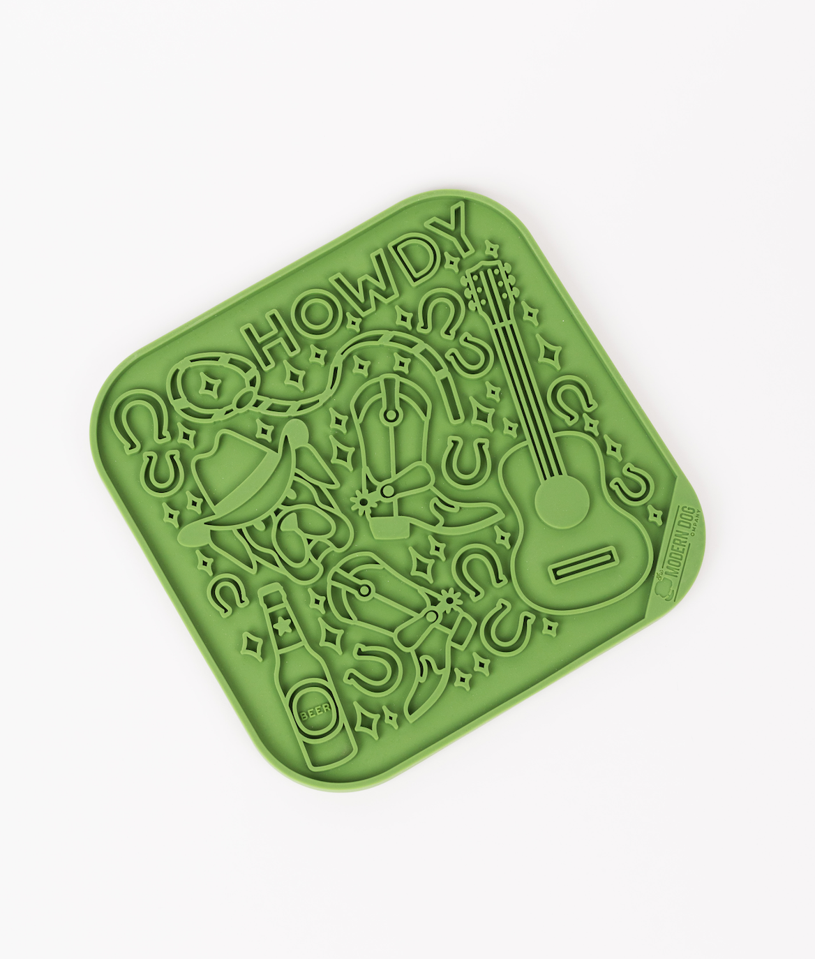 Green silicone lick mat featuring a "Howdy" design with a guitar, horseshoes, and a bottle, ideal for dogs.