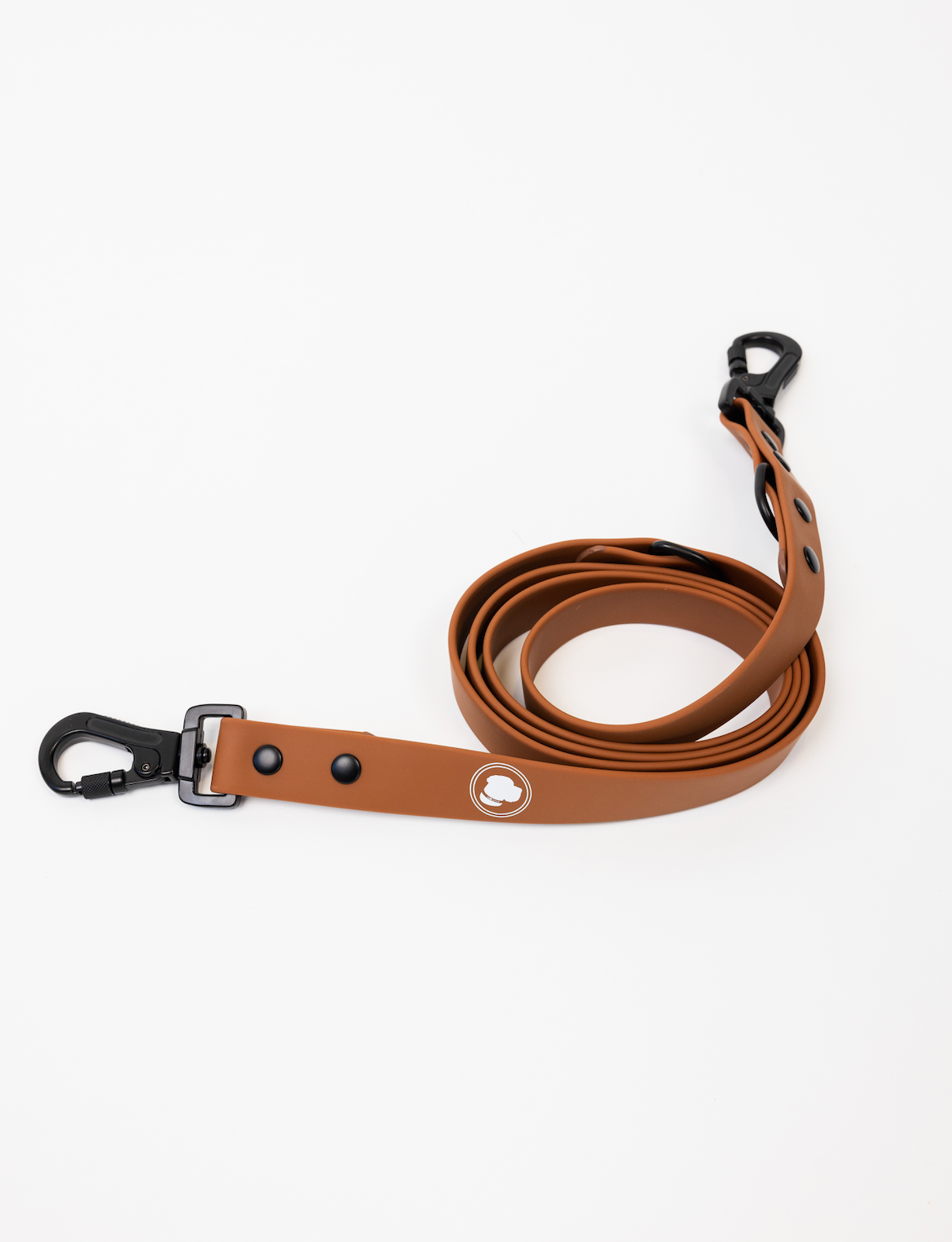 Coco Brown Leash by The Modern Dog Company, featuring a sleek design with a black clip and logo, coiled on a white background