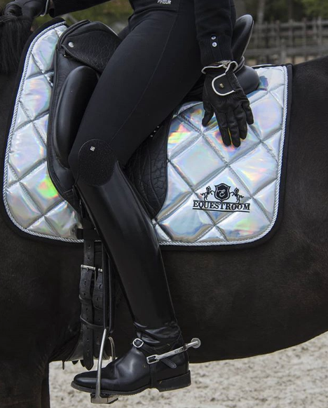 Holographic Saddle Pad by Southlake Paws on a horse, featuring a quilted design and a rider in black riding attire.