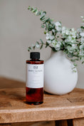 Load image into Gallery viewer, Luxury Electric Diffuser 8 oz refill bottle by Southlake Paws, displayed on a wooden table with a decorative vase and greener

